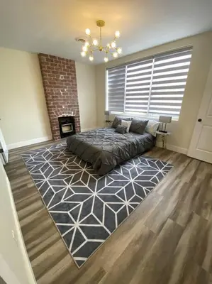 a living room with a bed and a fireplace at Modern & Luxurious 1 Bedroom in the Heart of Short North in Columbus