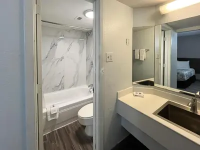 a bathroom with a sink and a toilet and a mirror at Studio 6 Suites Dayton OH Englewood in Dayton