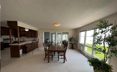 a kitchen and dining room with a table and chairs at 4 Bedroom Lakefront Home with Private Beach on Cedar Point Chaussee in Sandusky