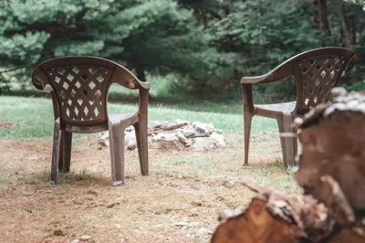 two wooden chairs sitting next to each other at Great Frontier Cabin at American Heartland Cabins in Rockbridge