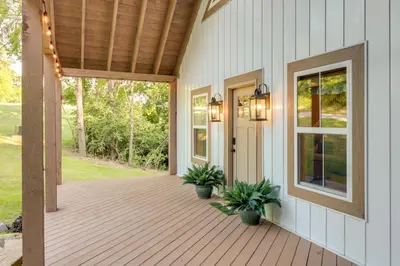 a front porch of a house with a wooden deck at Serene Kentucky Cabin with Fireplace and Fire Pit! in Williamstown