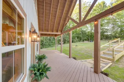 a covered porch of a house with a wooden ceiling at Serene Kentucky Cabin with Fireplace and Fire Pit! in Williamstown
