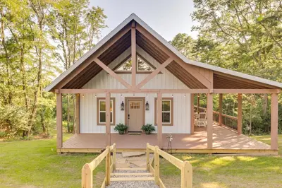 a small white cottage with a gambrel roof at Serene Kentucky Cabin with Fireplace and Fire Pit! in Williamstown