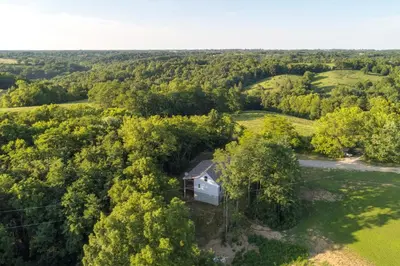 an aerial view of a house in the forest at Serene Kentucky Cabin with Fireplace and Fire Pit! in Williamstown