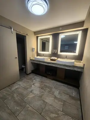 a bathroom with two sinks and two mirrors at Put-in-Bay Resort & Conference Center in Put-in-Bay