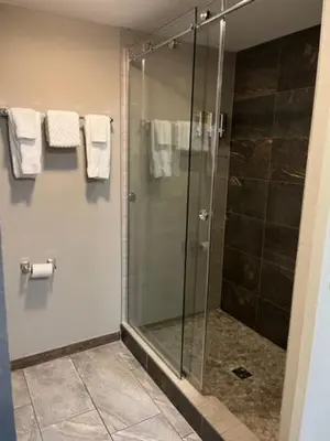a bathroom with a shower with a glass door at Put-in-Bay Resort & Conference Center in Put-in-Bay
