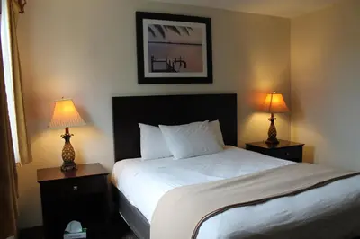 a bedroom with a bed and two lamps on tables at Put-in-Bay Resort & Conference Center in Put-in-Bay