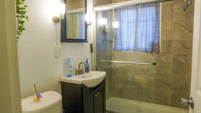 a bathroom with a shower and a sink and a toilet at Winter Retreat 2BR, Minutes from OSU & Downtown in Columbus