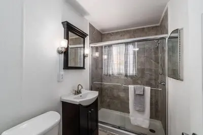 a bathroom with a shower and a sink and a toilet at Winter Retreat 2BR, Minutes from OSU & Downtown in Columbus