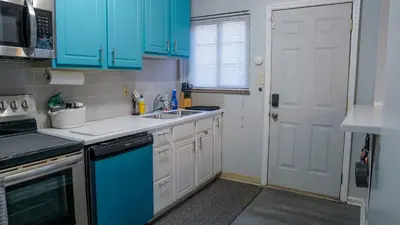 a kitchen with blue cabinets and a sink at Winter Retreat 2BR, Minutes from OSU & Downtown in Columbus