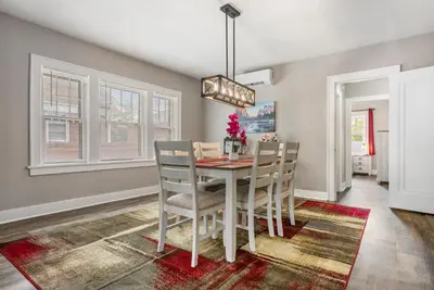 a dining room with a table and chairs at Apartments in the Heart of Canton in Canton
