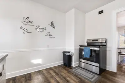 a kitchen with white walls and a stove at Apartments in the Heart of Canton in Canton