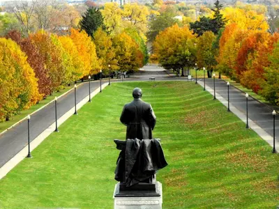 a statue of a man in the middle of a park at Apartments in the Heart of Canton in Canton