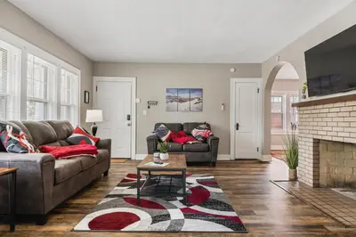 a living room with two couches and a fireplace at Apartments in the Heart of Canton in Canton