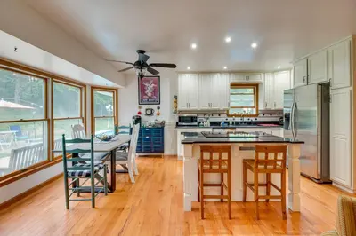 a kitchen with a table and chairs and a refrigerator at Pet-Friendly Union Vacation Rental with Pool! in Union