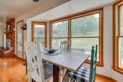 a dining room with a table and chairs and windows at Pet-Friendly Union Vacation Rental with Pool! in Union