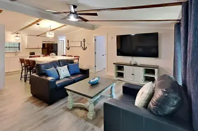 a living room with a couch and a table at Island Club Rentals in Put-in-Bay