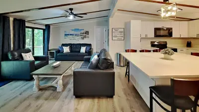 a kitchen and living room with a couch and a table at Island Club Rentals in Put-in-Bay