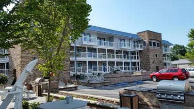 a building with a red car parked in a parking lot at Put-in-Bay Condos in Put-in-Bay