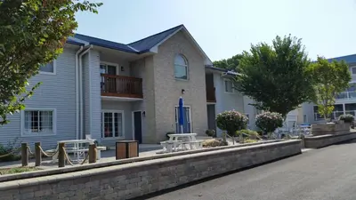 a building with tables and chairs in front of it at Put-in-Bay Condos in Put-in-Bay