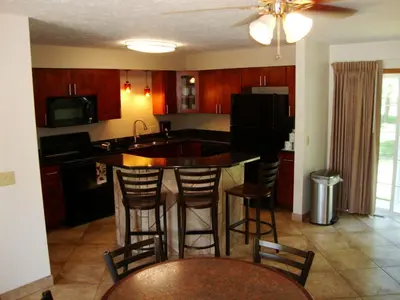 a kitchen with a island with bar stools at Put-in-Bay Condos in Put-in-Bay