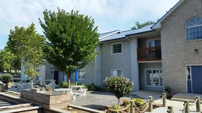 a house with a yard with a patio at Put-in-Bay Condos in Put-in-Bay