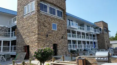 a large brick building with windows and a courtyard at Put-in-Bay Condos in Put-in-Bay
