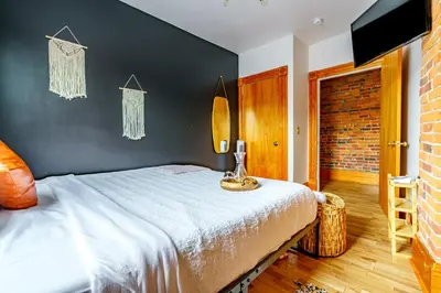 a bedroom with a bed and a black wall at Jungle House Columbus Downtown Free Parking Sleeps 8 - Walk to Convention Center & Nationwide Arena - 1BR Short North Luxury Home - Over 5,800 Five Star Stays in Columbus