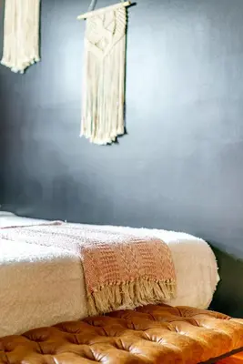 a bed with a blanket on top of it in a room at Jungle House Columbus Downtown Free Parking Sleeps 8 - Walk to Convention Center & Nationwide Arena - 1BR Short North Luxury Home - Over 5,800 Five Star Stays in Columbus