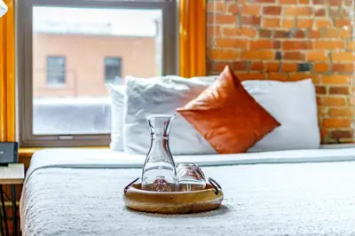 a glass vase sitting on top of a bed at Jungle House Columbus Downtown Free Parking Sleeps 8 - Walk to Convention Center & Nationwide Arena - 1BR Short North Luxury Home - Over 5,800 Five Star Stays in Columbus