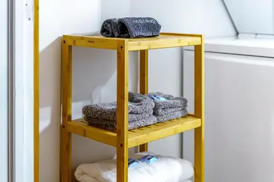 a wooden towel rack with towels on it at Jungle House Columbus Downtown Free Parking Sleeps 8 - Walk to Convention Center & Nationwide Arena - 1BR Short North Luxury Home - Over 5,800 Five Star Stays in Columbus