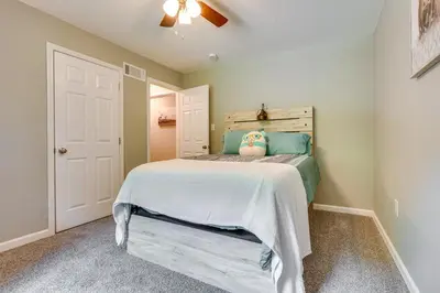 a bedroom with a bed with a white bedspread at Outdoor Entertainment Areas Family Ohio Getaway in Howard