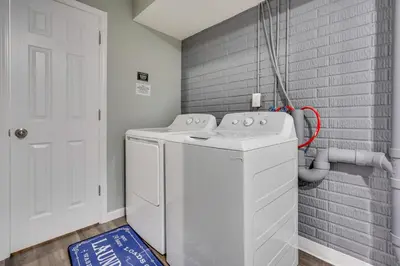 a white washer and dryer in a laundry room at Outdoor Entertainment Areas Family Ohio Getaway in Howard