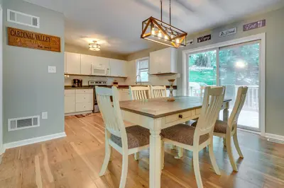 a kitchen and dining room with a wooden table and chairs at Outdoor Entertainment Areas Family Ohio Getaway in Howard