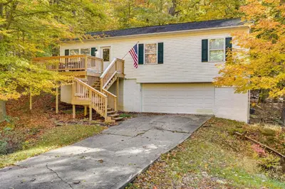 a house with a wooden staircase in front of it at Outdoor Entertainment Areas Family Ohio Getaway in Howard