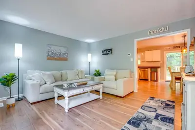 a living room with two white couches and a table at Outdoor Entertainment Areas Family Ohio Getaway in Howard