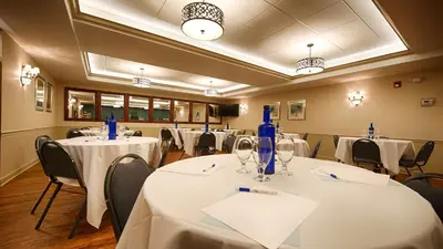 a conference room with white tables and chairs and blue bottles at Best Western Plus Mentor-Cleveland Northeast in Mentor