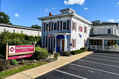 a building with a sign in a parking lot at Best Western Plus Mentor-Cleveland Northeast in Mentor