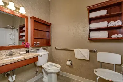 a bathroom with a toilet and a sink and a mirror at Best Western Plus Mentor-Cleveland Northeast in Mentor