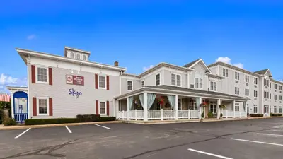 a large white building with a parking lot in front of it at Best Western Plus Mentor-Cleveland Northeast in Mentor
