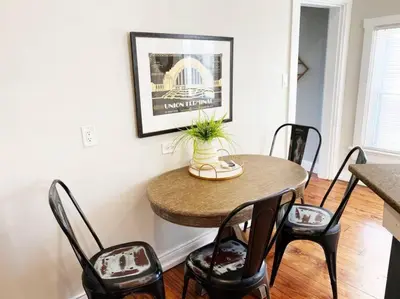 a dining room with a table and four chairs at 2 Large Apts w Parking - Downtown Over the Rhine in Cincinnati