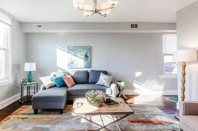 a living room with a blue couch and a table at 2 Large Apts w Parking - Downtown Over the Rhine in Cincinnati