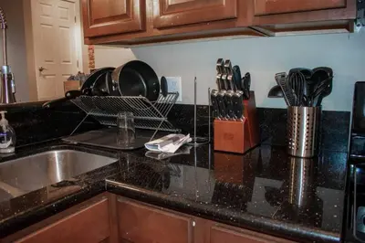 a kitchen counter with a sink and utensils at Huge Parkside Retreat - Private Roof Decks in Cincinnati