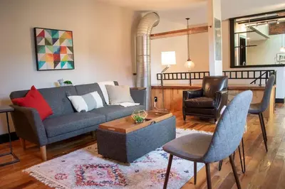 a living room with a couch and two chairs at Huge Parkside Retreat - Private Roof Decks in Cincinnati