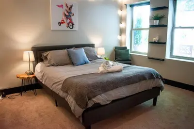 a bedroom with a bed with a stuffed animal on it at Huge Parkside Retreat - Private Roof Decks in Cincinnati