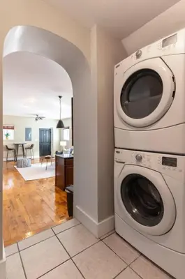 a washer and dryer in a room with a kitchen at Broadway Suites - Stunning Downtown Condos in Cincinnati