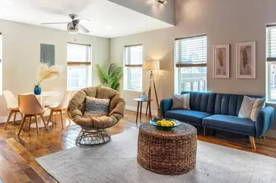 a living room with a couch and chairs and a table at Broadway Suites - Stunning Downtown Condos in Cincinnati