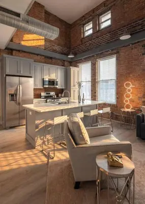 a kitchen with a couch and a counter in a room at Entire Historic Building Sleeps 30 in Cincinnati