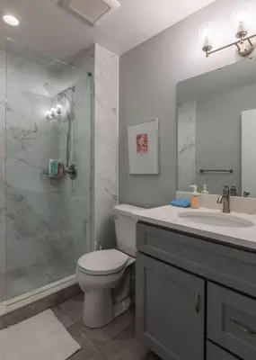 a bathroom with a shower and a toilet and a sink at Entire Historic Building Sleeps 30 in Cincinnati
