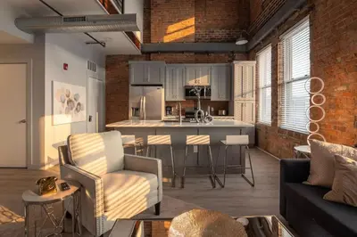 a kitchen and living room with a couch and a table at Entire Historic Building Sleeps 30 in Cincinnati